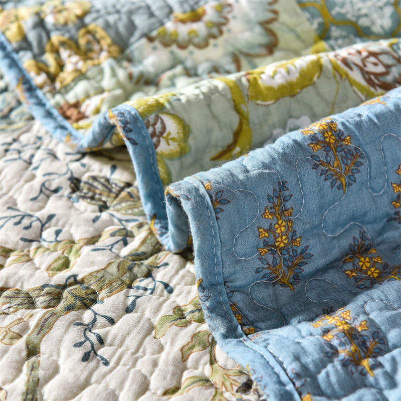 Enchanting Bohemian - Style Quilt Showcasing Intricate Floral Stitching, Complete with Matching Pillowcases